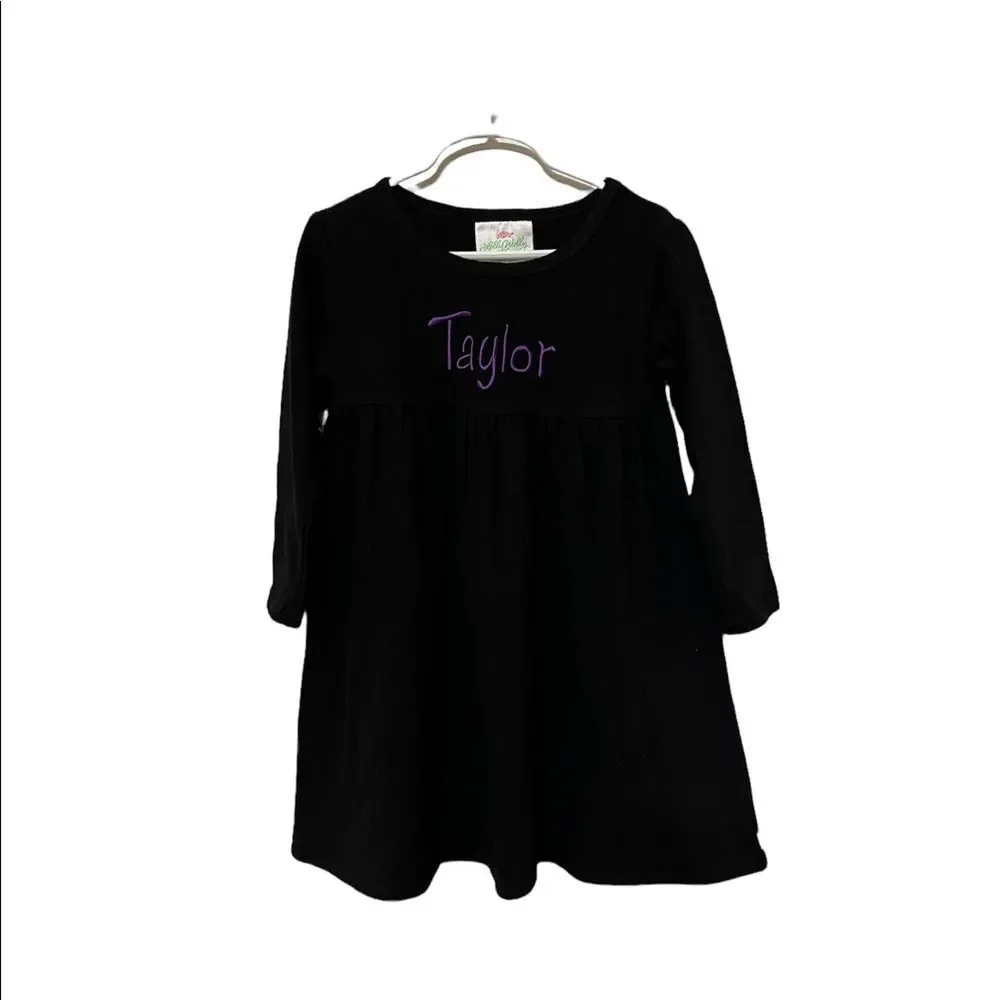 Black long sleeve dress with the name Taylor embroidered on the front girls 4